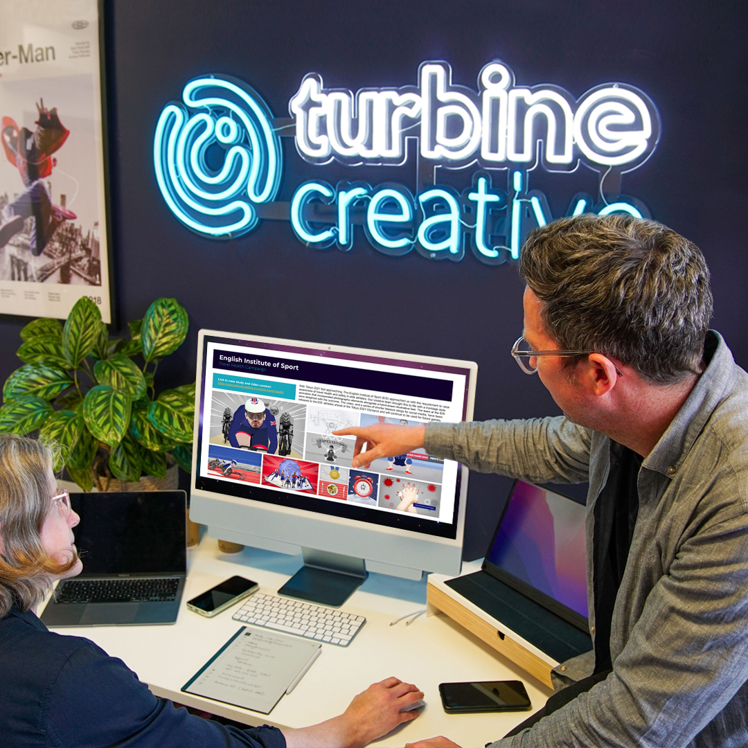 Turbine Creative team reviewing work on screen